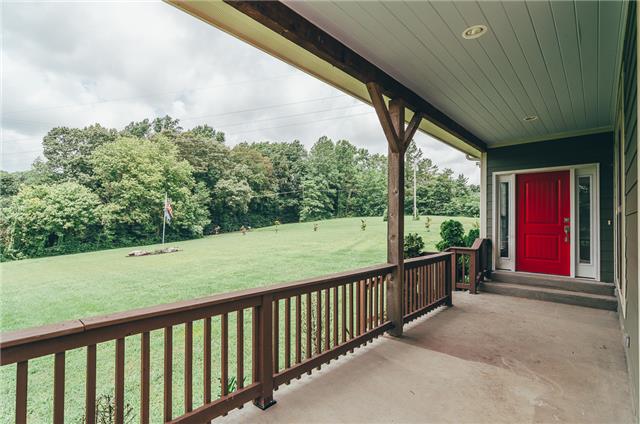 3761 Clarity Road Springfield, TN 37172 - Photo 4 of 20 Cedar railings surround this covered porch. This red door will brighten your day each time you see it!