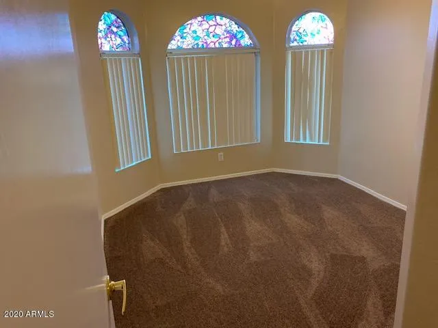 a view of an empty room with windows