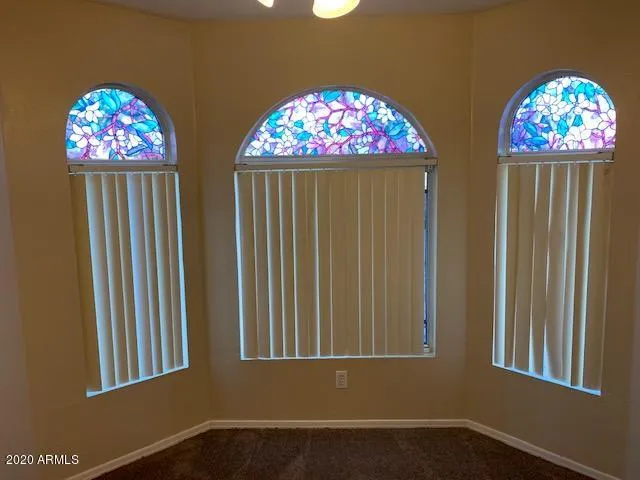 a view of room with windows and furniture