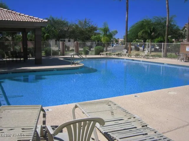 a view of a patio with swimming pool table and chairs