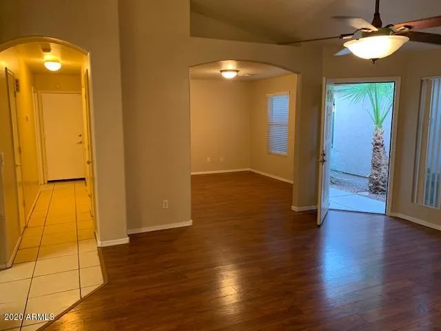 an empty room with wooden floor and door