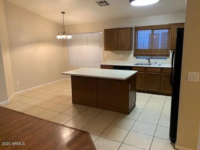 a kitchen with stainless steel appliances a sink stove and cabinets