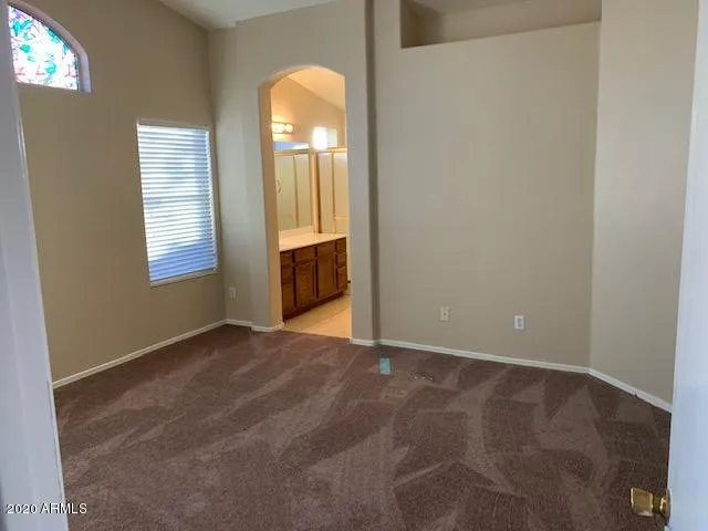 an empty room with windows and closet
