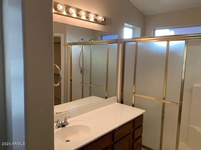 a bathroom with a sink vanity and a mirror