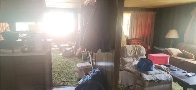 a living room with furniture a mirror and a lamp