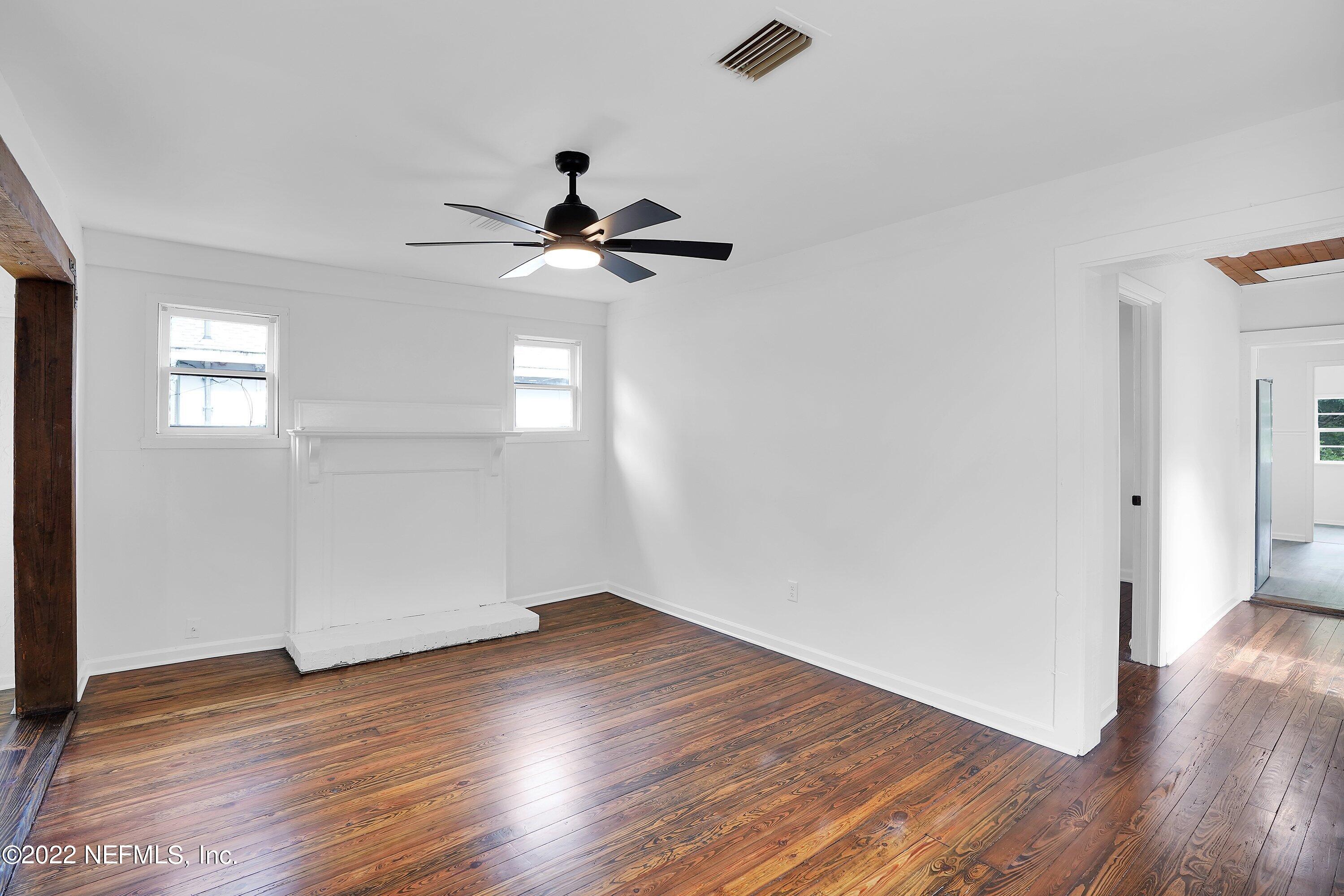 1441 Rensselaer Avenue Jacksonville, FL 32205 - Photo 12 of 35 a view of an empty room with wooden floor and a window