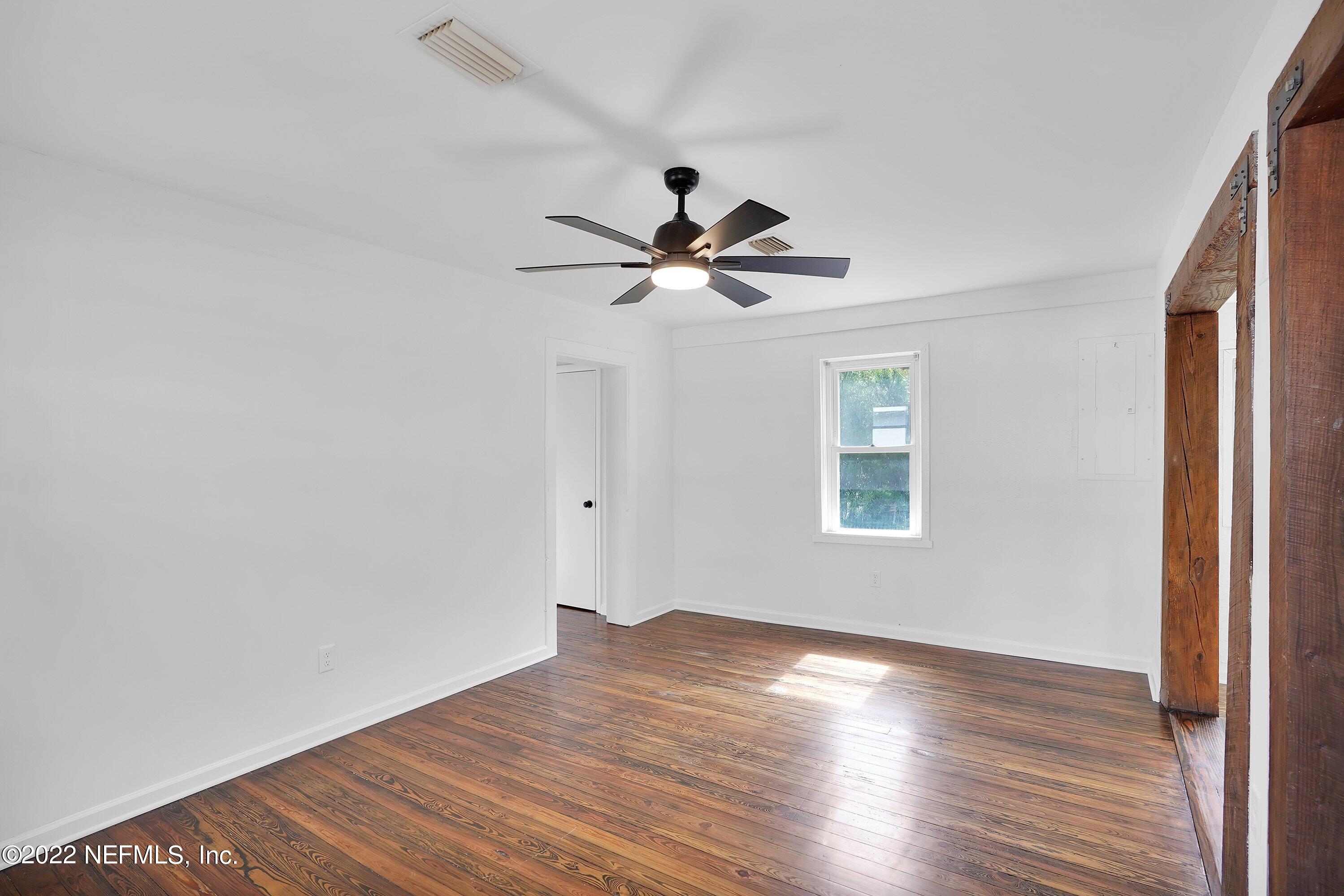 1441 Rensselaer Avenue Jacksonville, FL 32205 - Photo 13 of 35 an empty room with wooden floor and windows