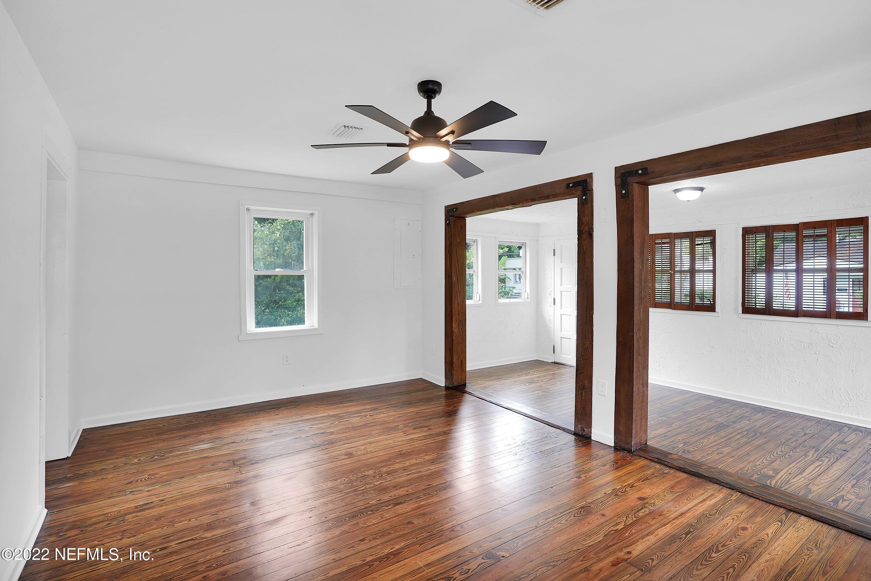 1441 Rensselaer Avenue Jacksonville, FL 32205 - Photo 15 of 35 a view of a livingroom with wooden floor a ceiling fan and windows