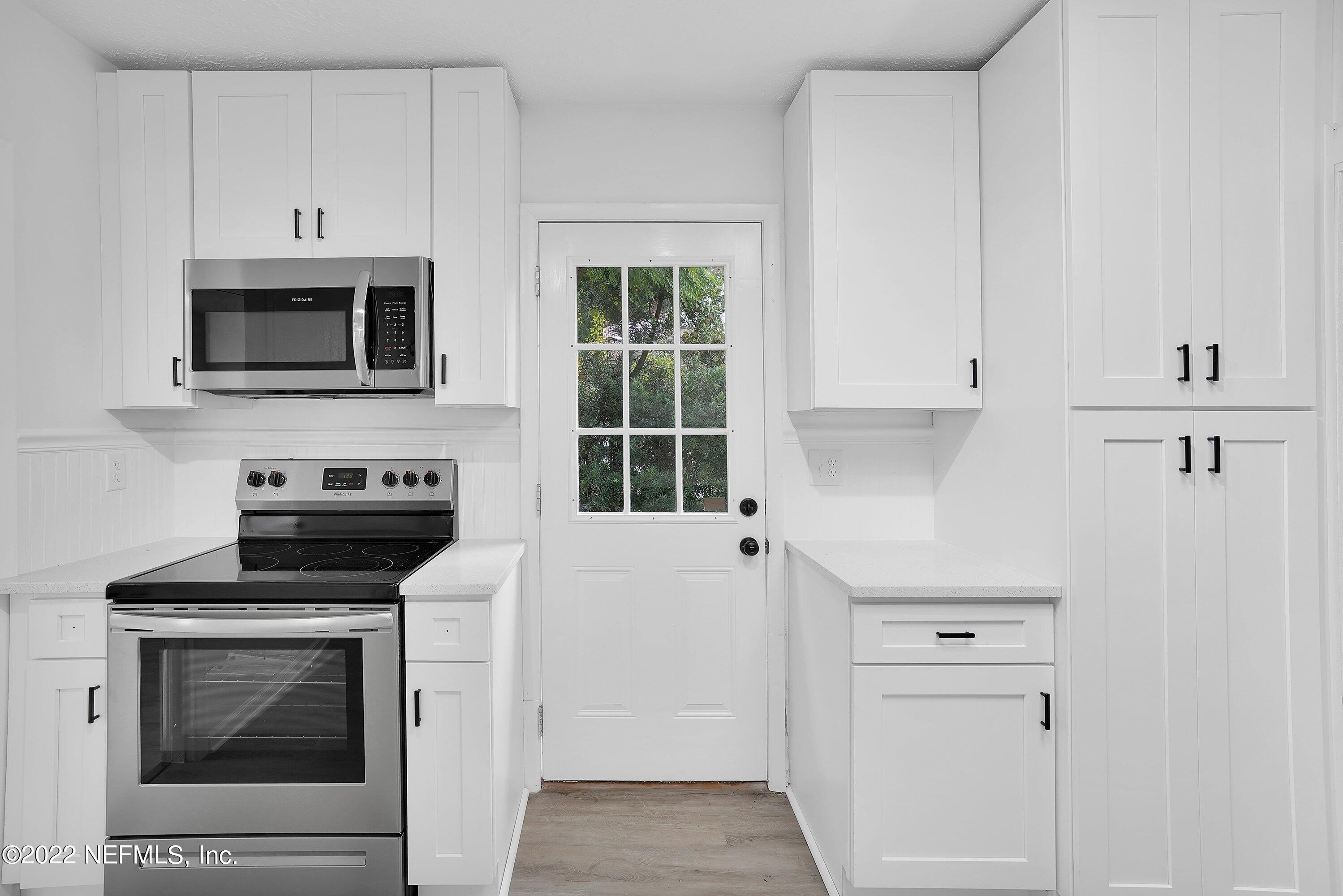 1441 Rensselaer Avenue Jacksonville, FL 32205 - Photo 21 of 35 a kitchen with cabinets stainless steel appliances and a window