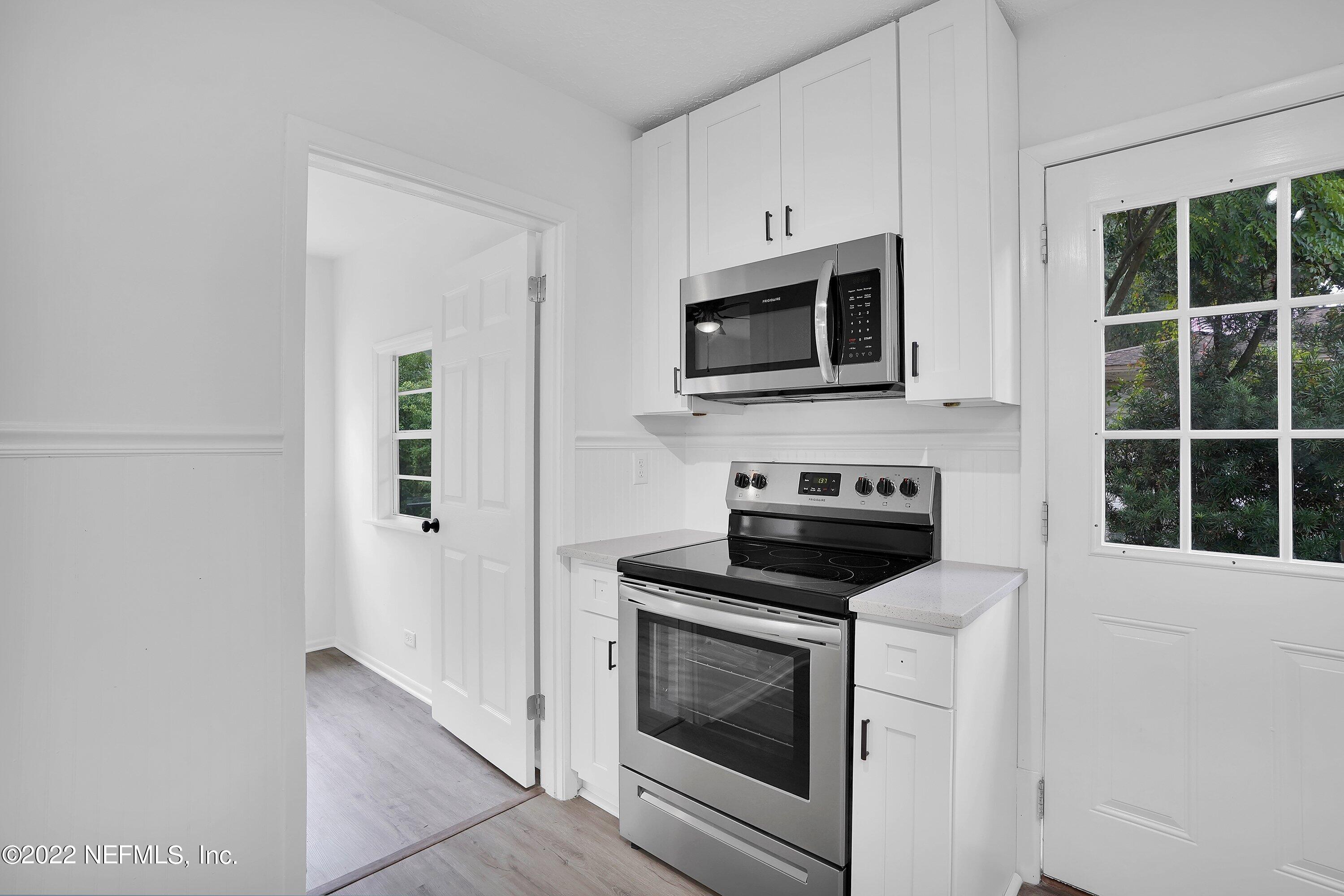 1441 Rensselaer Avenue Jacksonville, FL 32205 - Photo 22 of 35 a kitchen with microwave cabinets and stainless steel appliances