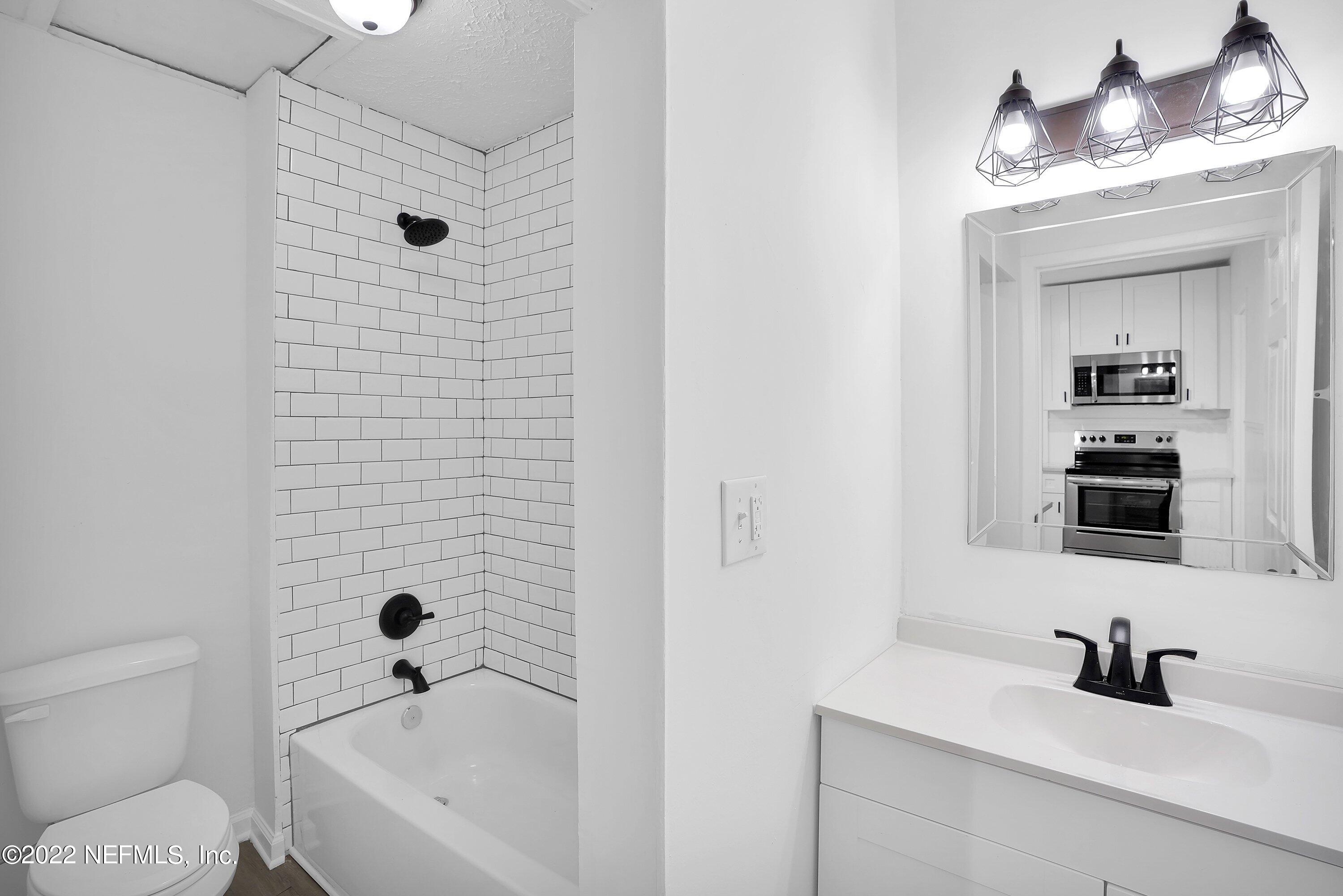 1441 Rensselaer Avenue Jacksonville, FL 32205 - Photo 25 of 35 a bathroom with a sink a toilet and shower