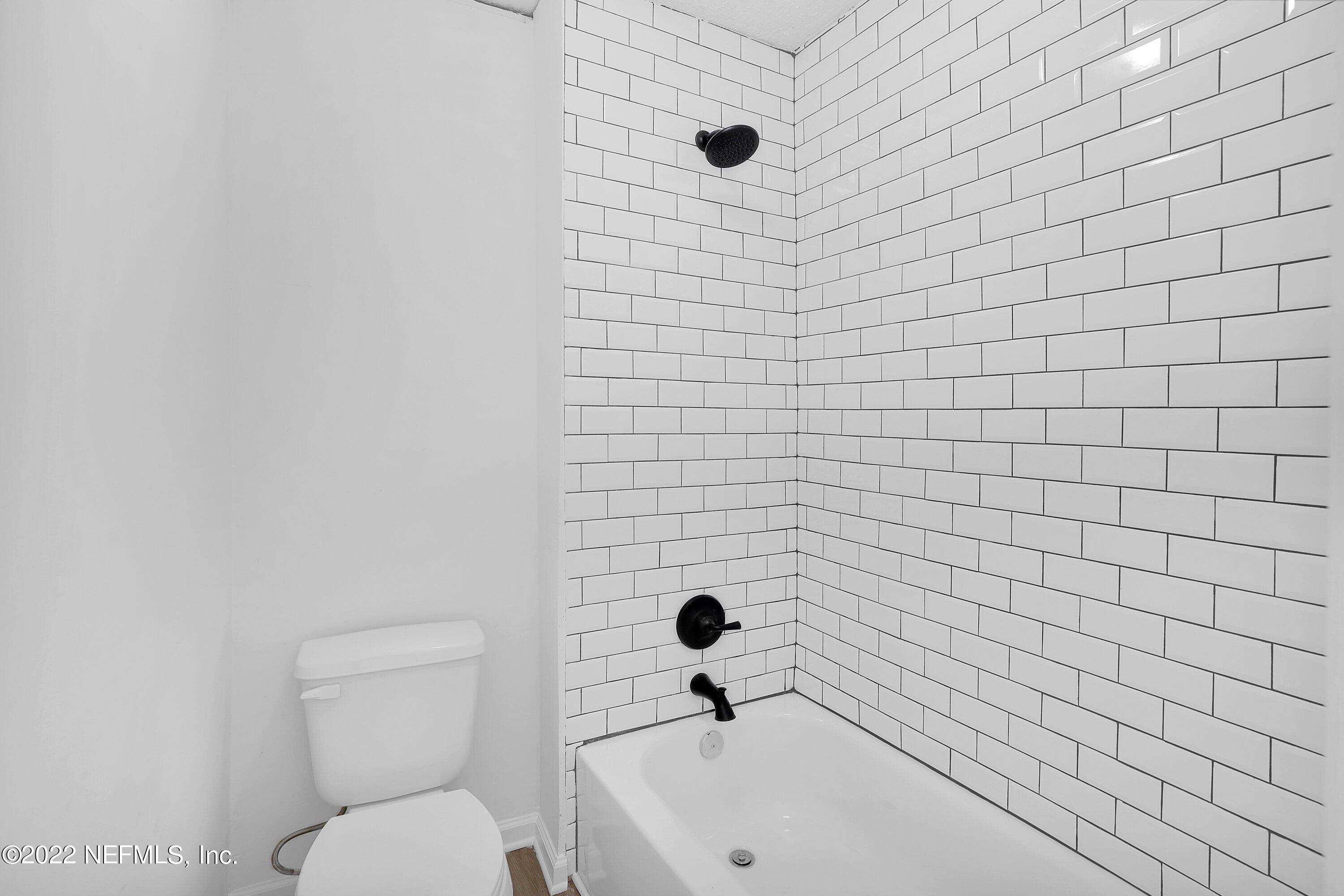 1441 Rensselaer Avenue Jacksonville, FL 32205 - Photo 26 of 35 a bathroom with a white toilet and a shower