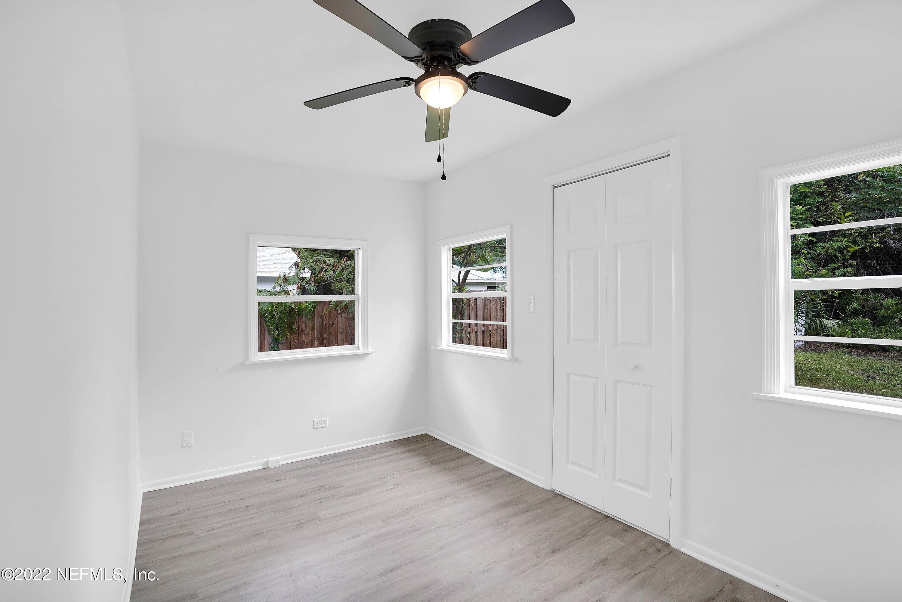 1441 Rensselaer Avenue Jacksonville, FL 32205 - Photo 27 of 35 a view of an empty room with a window and wooden floor