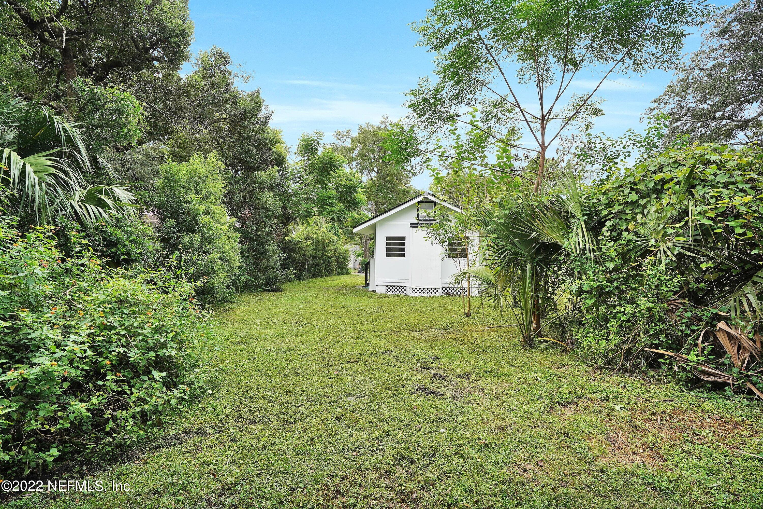 1441 Rensselaer Avenue Jacksonville, FL 32205 - Photo 34 of 35 a backyard of a house with plants and large trees