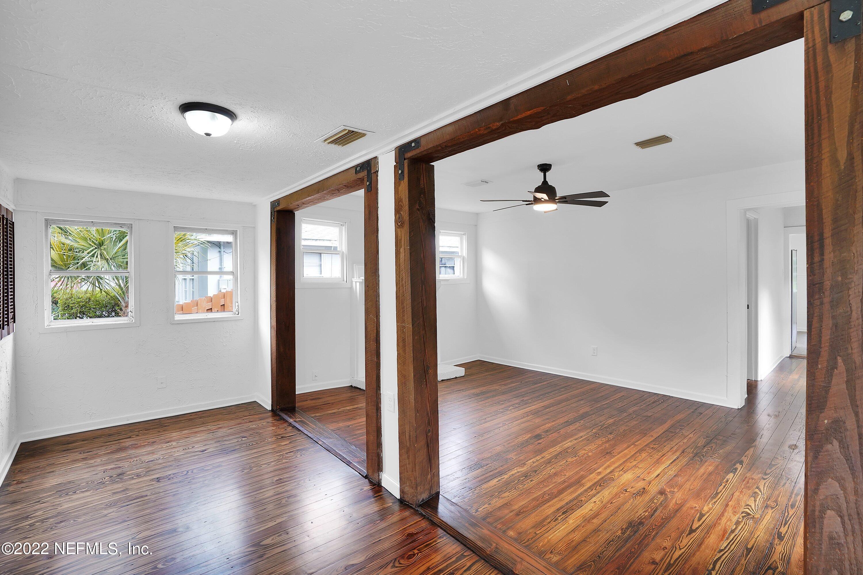 1441 Rensselaer Avenue Jacksonville, FL 32205 - Photo 8 of 35 an empty room with wooden floor and windows