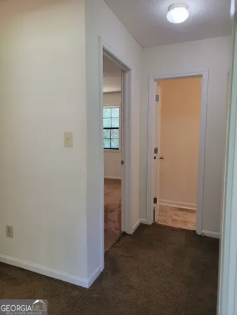 an empty room with closet and a bathroom