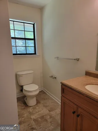 a bathroom with a toilet sink and mirror