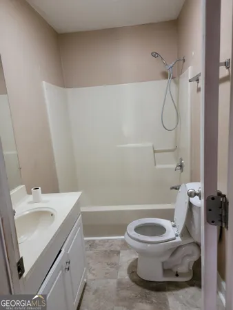a white toilet sitting next to a bathroom sink