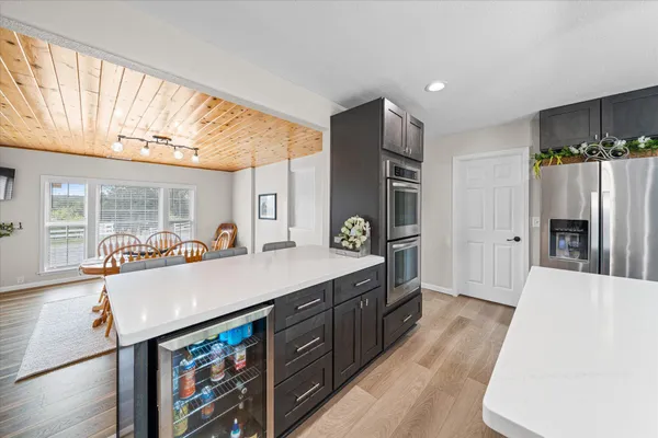 a kitchen with stainless steel appliances granite countertop a sink a stove and a refrigerator