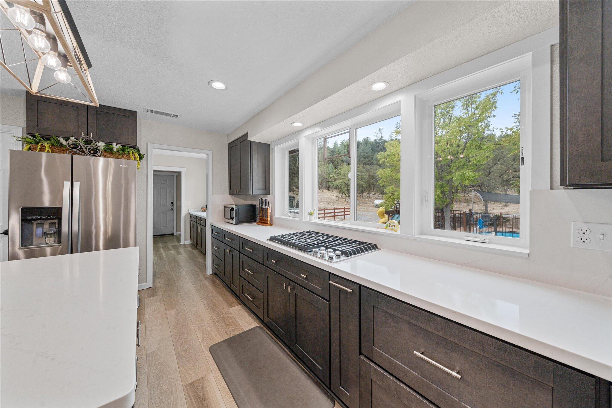 10190 Oak Run Road Oak Run, CA 96069 - Photo 14 of 81 a kitchen with stainless steel appliances granite countertop a refrigerator a stove and a sink