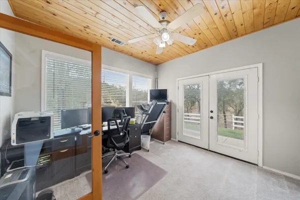 a bedroom with furniture and a large window