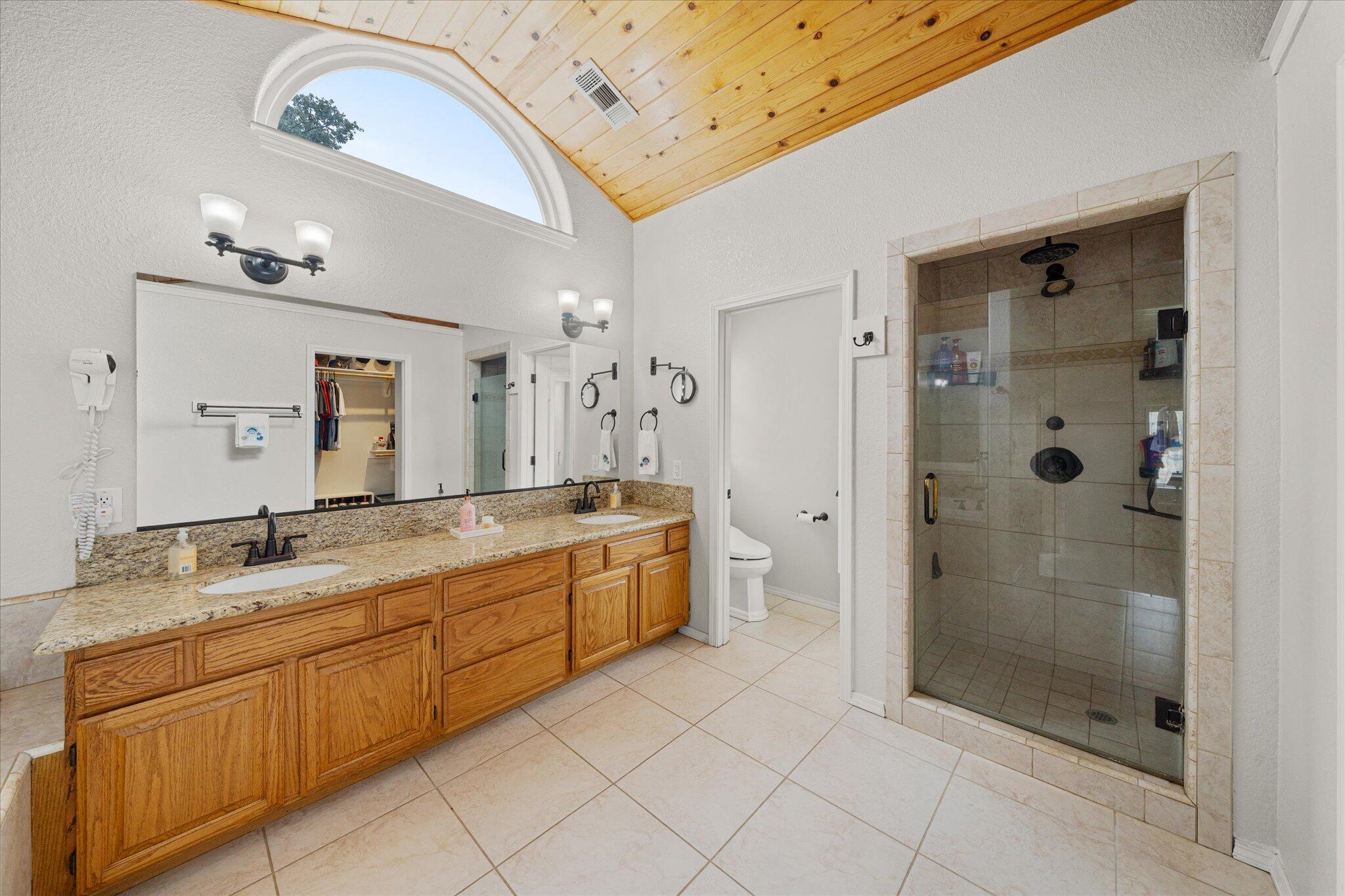 10190 Oak Run Road Oak Run, CA 96069 - Photo 28 of 81 a bathroom with a granite countertop sink a mirror and a shower