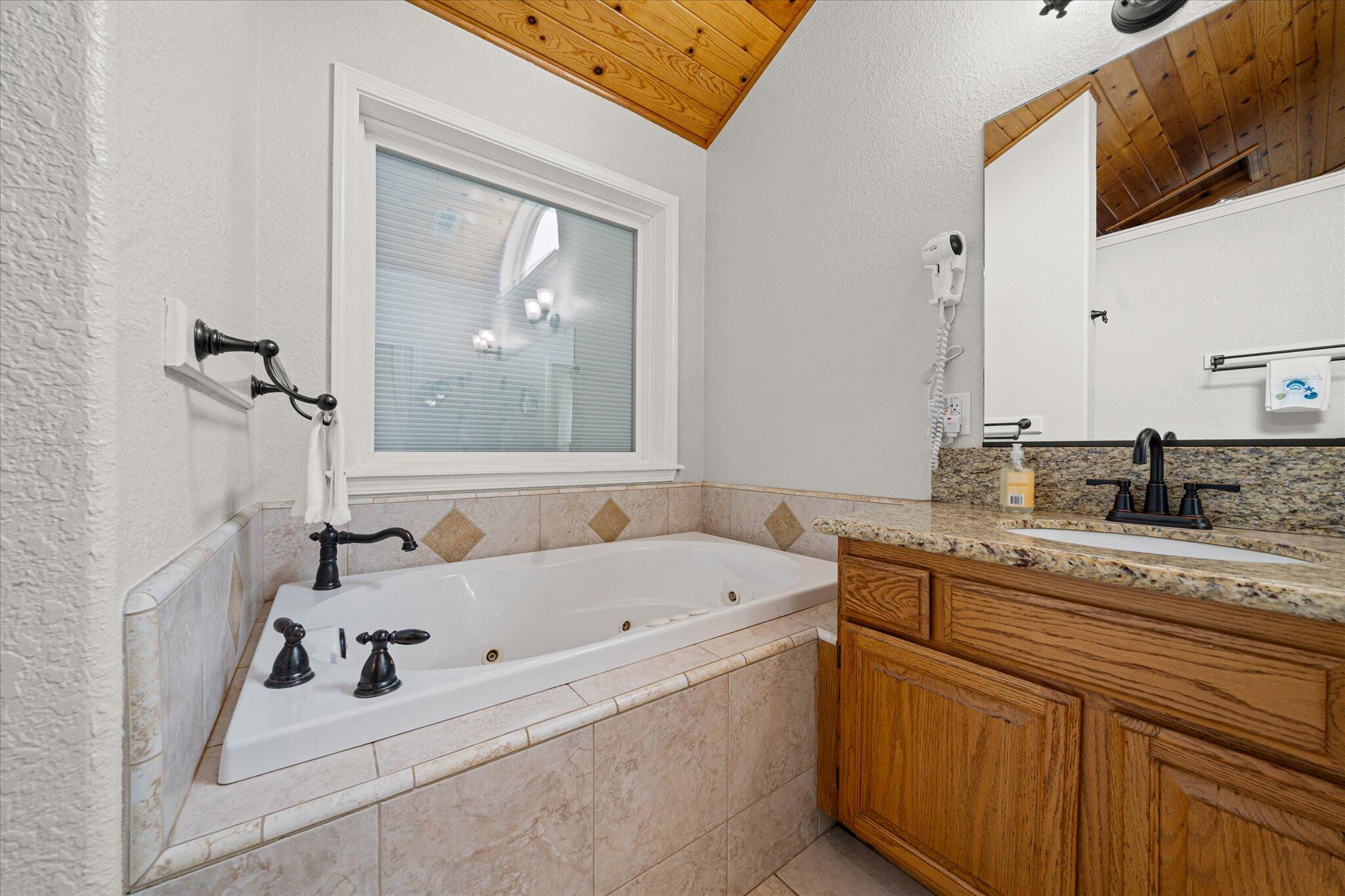 10190 Oak Run Road Oak Run, CA 96069 - Photo 30 of 81 a bathroom with a tub sink and mirror