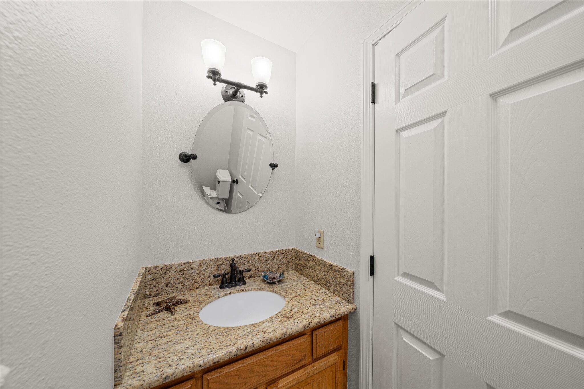 10190 Oak Run Road Oak Run, CA 96069 - Photo 38 of 81 a bathroom with a granite countertop sink and a mirror
