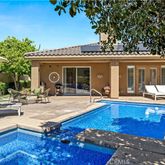 a view of a house with swimming pool and sitting area
