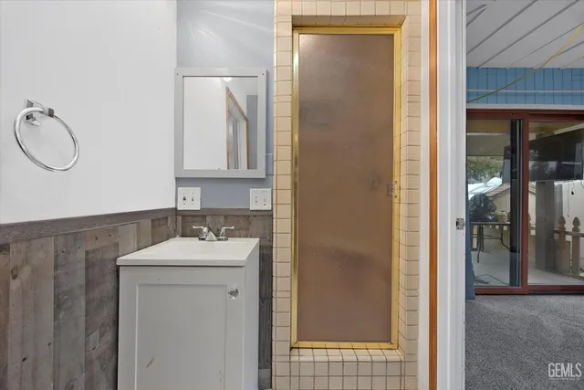 a bathroom with a sink vanity mirror and toilet