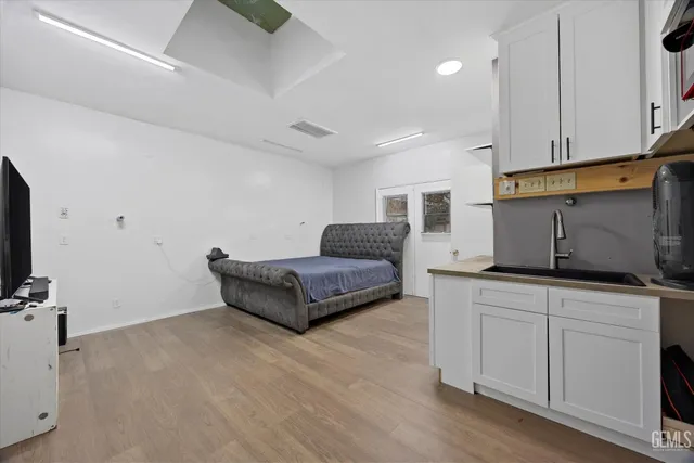 a living room with furniture and kitchen view