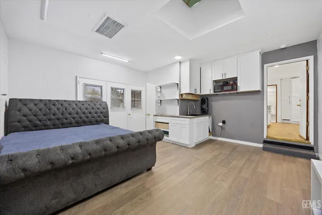 a bedroom with a bed and a flat screen tv