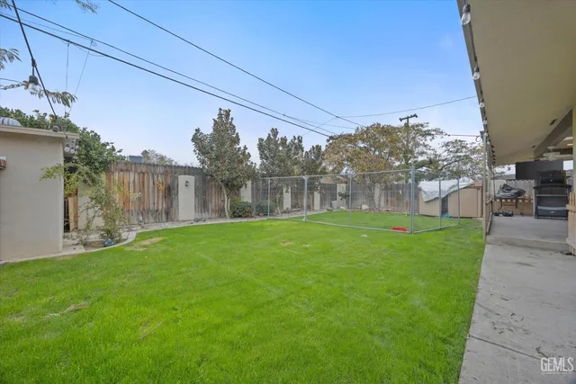 a view of a house with a backyard and a patio