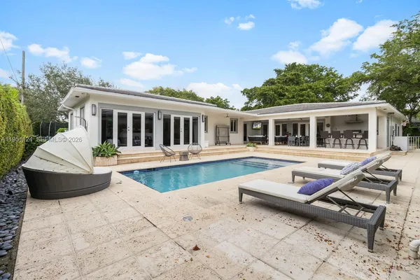 a view of a house with pool and wooden floor