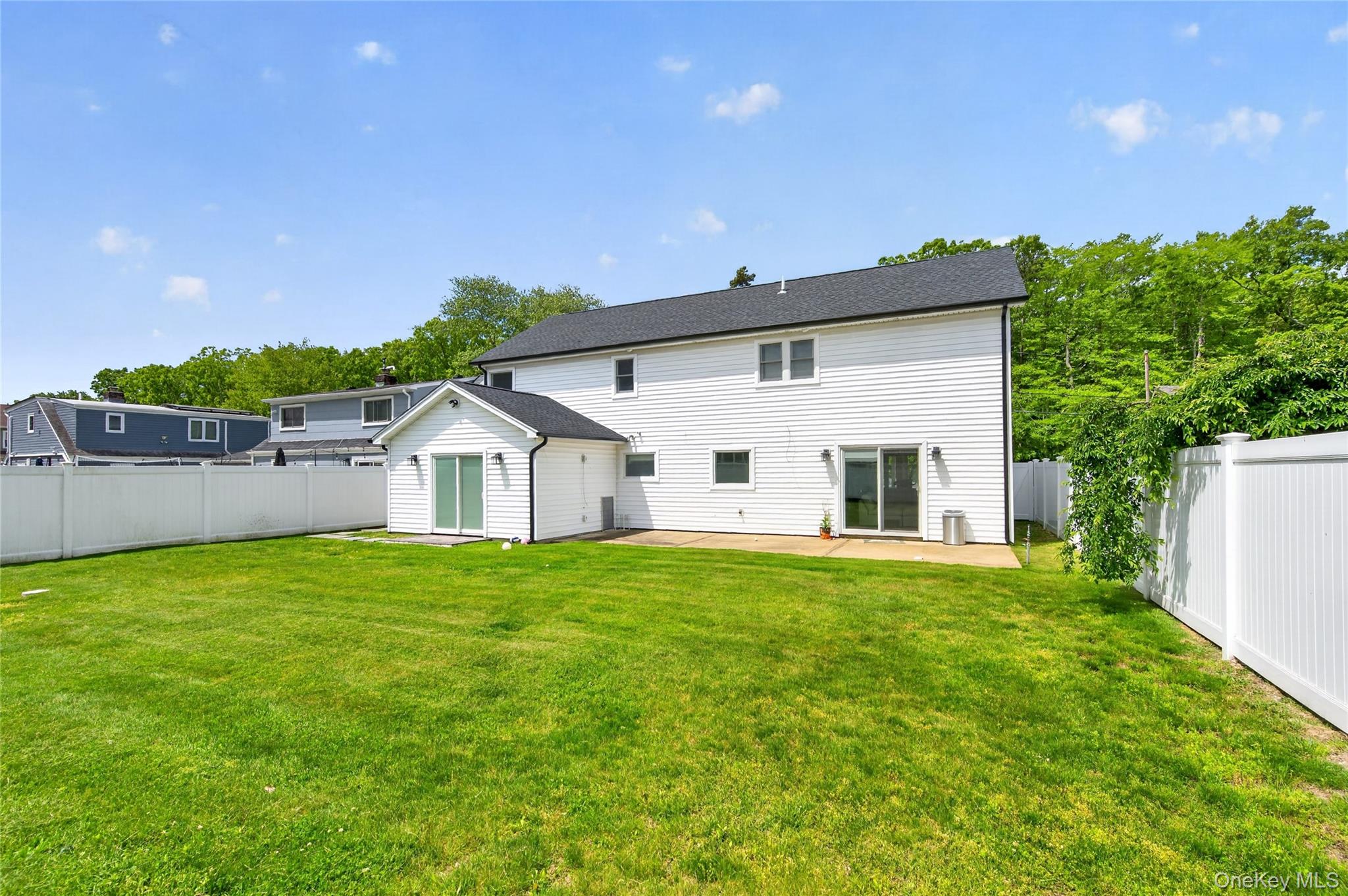 534 Riverside Avenue Massapequa, NY 11758 - Photo 27 of 28 a front view of a house with a yard and trees