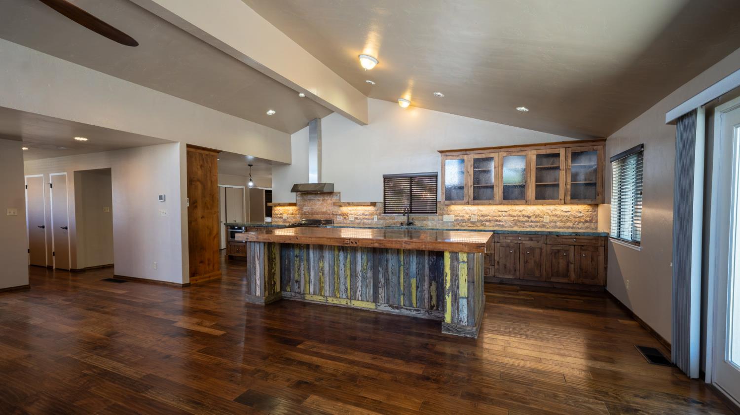 118 Main Street Murphys, CA 95247 - Photo 11 of 47 a kitchen with stainless steel appliances kitchen island granite countertop a refrigerator and a stove top oven