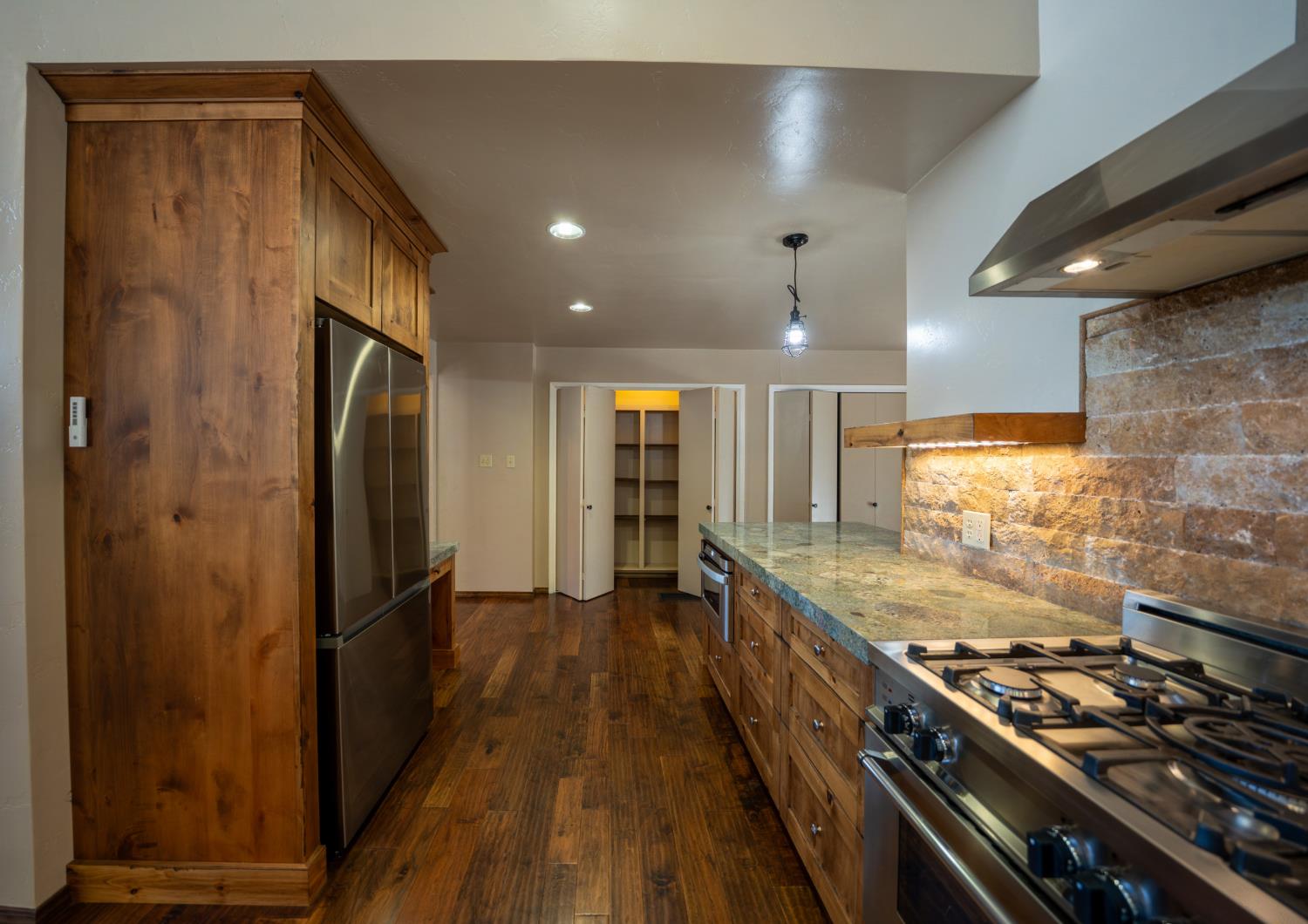118 Main Street Murphys, CA 95247 - Photo 16 of 47 a kitchen with stainless steel appliances granite countertop a refrigerator and a stove
