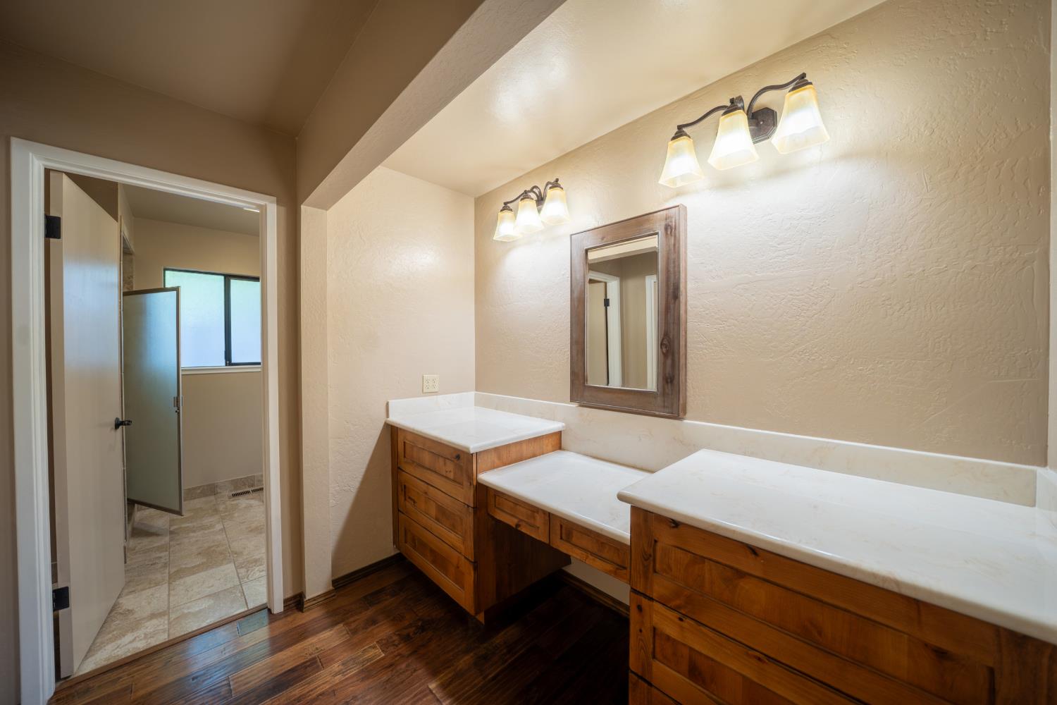 118 Main Street Murphys, CA 95247 - Photo 23 of 47 a bathroom with a sink a mirror and a shower