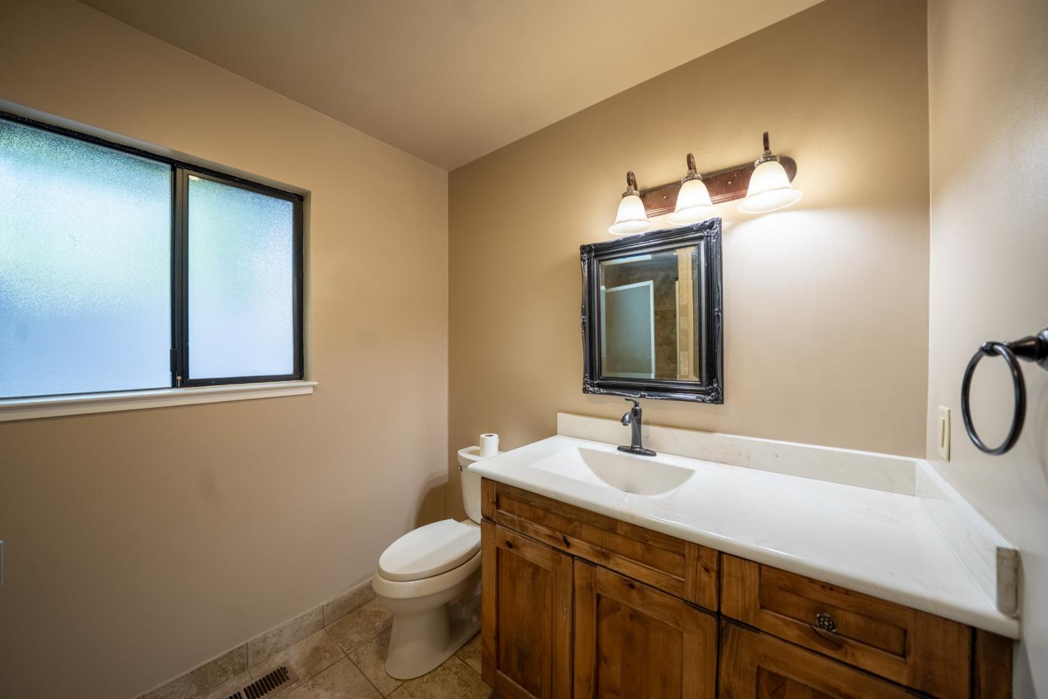 118 Main Street Murphys, CA 95247 - Photo 24 of 47 a bathroom with a sink a toilet and mirror
