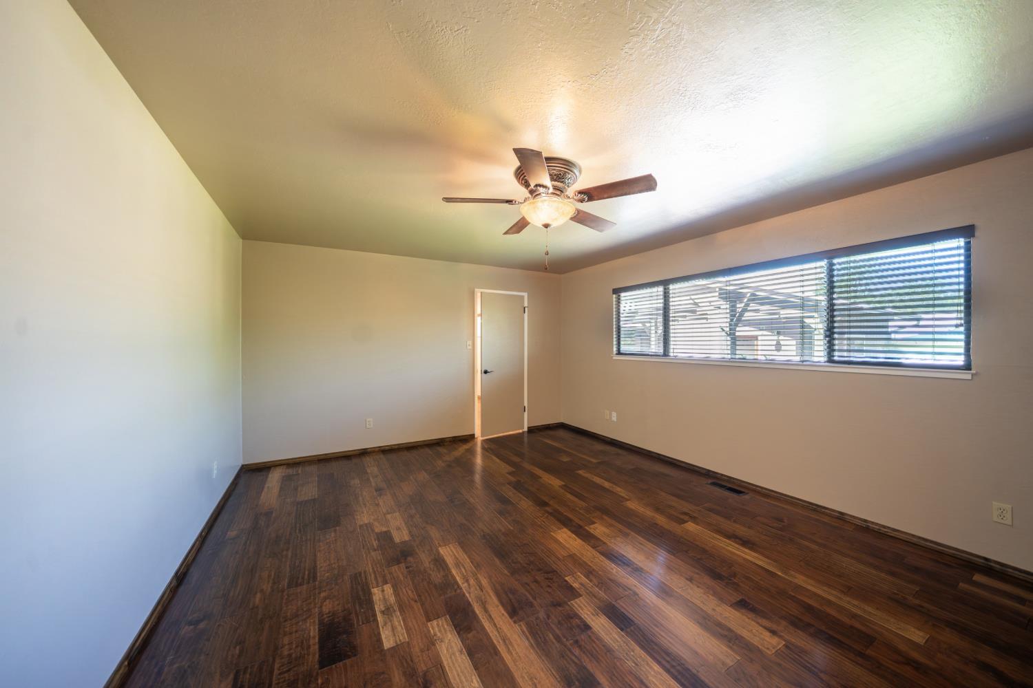 118 Main Street Murphys, CA 95247 - Photo 29 of 47 a view of an empty room with a window and wooden floor