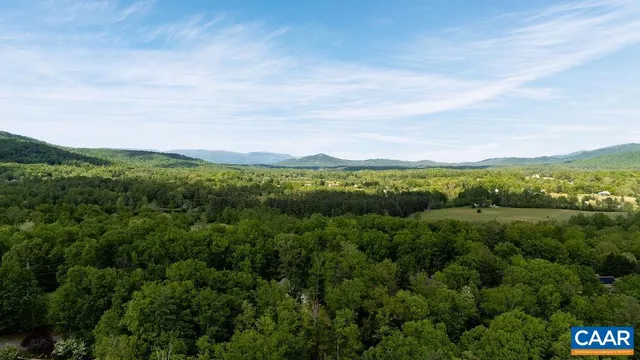 a view of a lush green hillside and houses