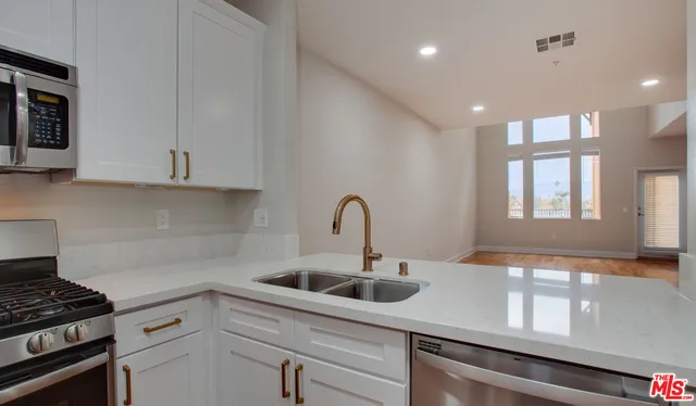 a kitchen with a sink and cabinets