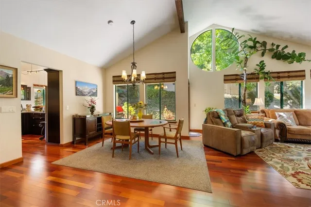 a view of a table and chairs under an umbrella in the balcony