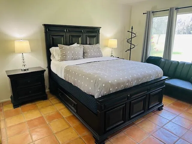 a bedroom with a bed and window