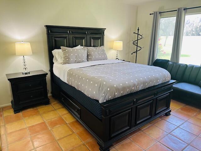 40511 Pebble Beach Circle Palm Desert, CA 92211 - Photo 11 of 26 a bedroom with a bed and a lamp