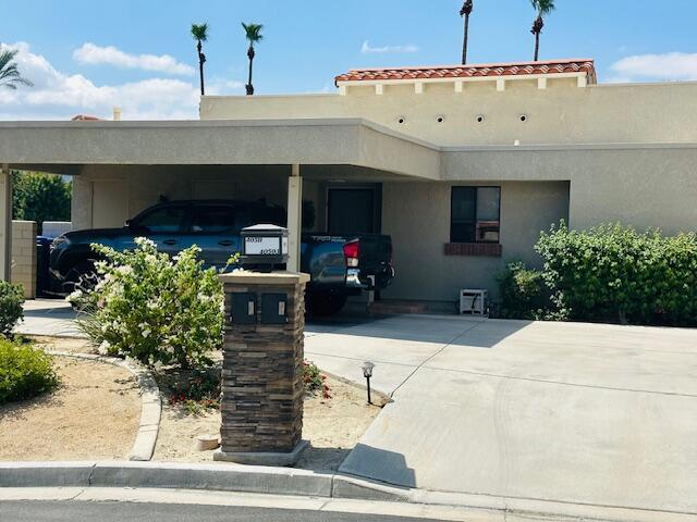 40511 Pebble Beach Circle Palm Desert, CA 92211 - Photo 20 of 26 a front view of a house with potted plants