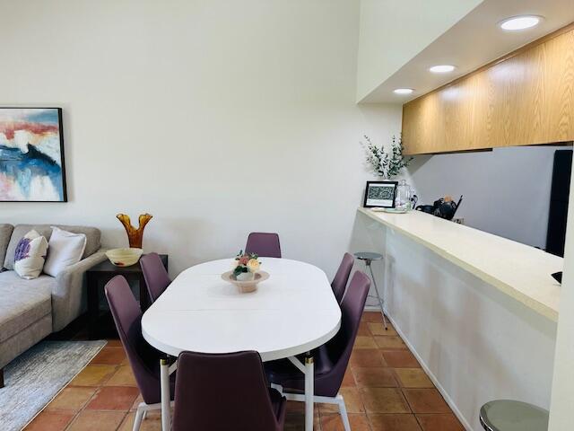 40511 Pebble Beach Circle Palm Desert, CA 92211 - Photo 4 of 26 a view of a dining room with furniture and wooden floor