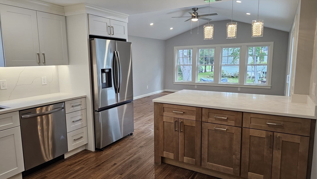26 Eleanor Road Framingham, MA 01701 - Photo 8 of 15 a kitchen with stainless steel appliances a refrigerator and wooden cabinets