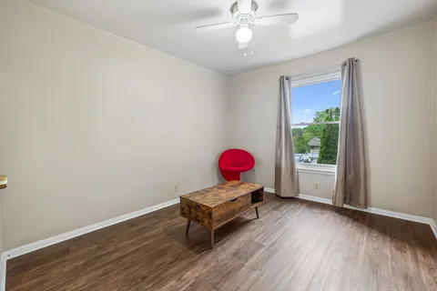 a room with wooden floor and furniture