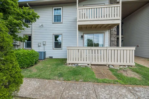 a view of a house with a yard and deck